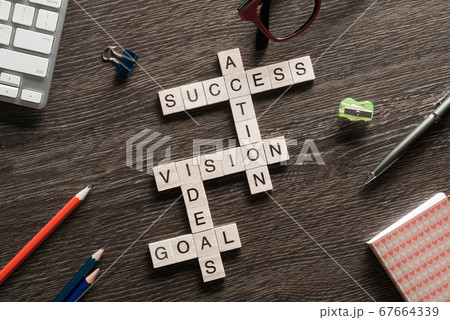 Success achieving business keywords collected of wooden cubes in crossword Success achieving business keywords collected of wooden cubes in crossword 67664339