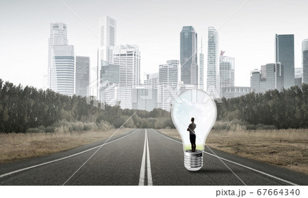 Businesswoman inside light bulb 67664340