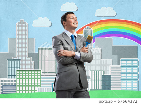 Creative businessman painter holding paintbrush Creative businessman painter holding paintbrush 67664372