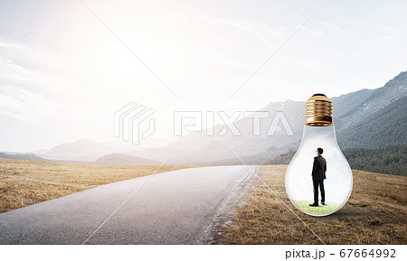 Businessman inside light bulb Businessman inside light bulb 67664992