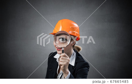 Technical inspector looking through magnifier Technical inspector looking through magnifier 67665485
