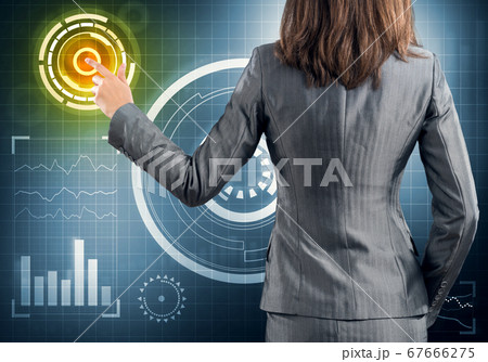 Businesswoman standing with back and pressing icon on media screen 67666275
