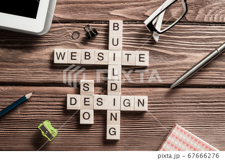 Conceptual media keywords on table with elements of game making crossword 67666276