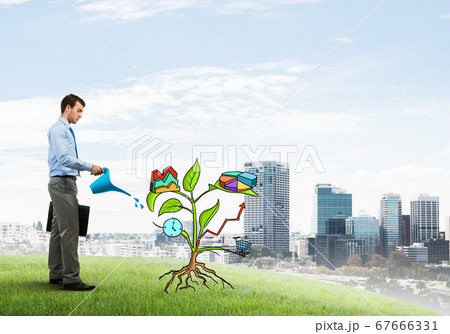 Young businessman outdoors watering drawn growth concept with can Young businessman outdoors watering drawn growth concept with can 67666331