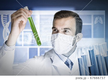 Portrait of concentrated male scientist working with reagents in laboratory 67666737