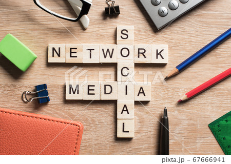 Conceptual media keywords on table with elements of game making crossword Conceptual media keywords on table with elements of game making crossword 67666941