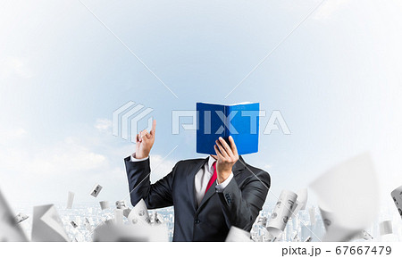 Businessman covered his face with organizer Businessman covered his face with organizer 67667479