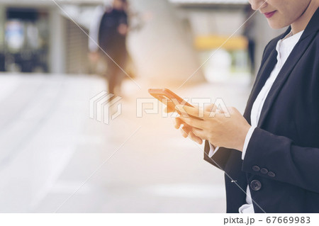 Asian woman using smartphone reading online social Asian woman using smartphone reading online social 67669983