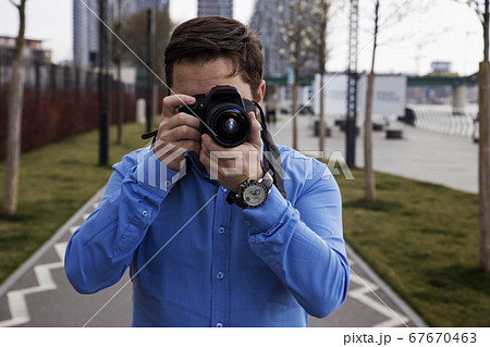 Photographer photographing outdoors. Shooting in Photographer photographing outdoors. Shooting in 67670463