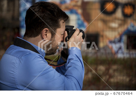 Photographer photographing outdoors. Shooting in 67670464