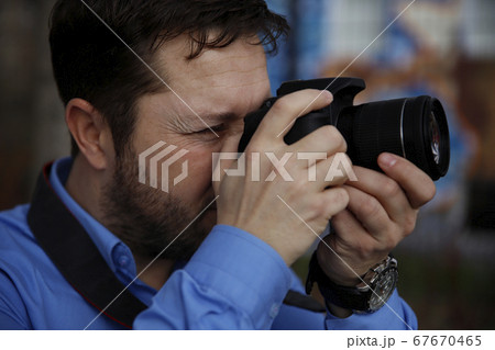 Photographer photographing outdoors. Shooting in Photographer photographing outdoors. Shooting in 67670465