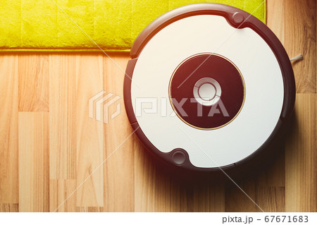 Robot vacuum cleaner on laminate wood floor Robot vacuum cleaner on laminate wood floor 67671683