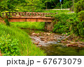 田舎の夕日に照らされる橋と川 67673079
