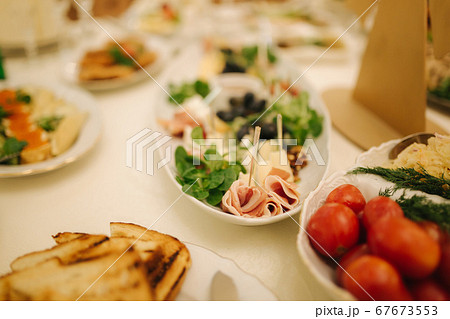 Table with food and drink on wedding. Served and decorated table in restaurant Table with food and drink on wedding. Served and decorated table in restaurant 67673553