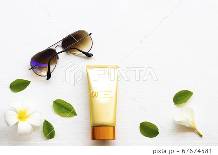 natural cosmetics sunscreen spf50 health care for skin face with sunglasses ,flowers frangipani ,leaf of lifestyle woman natural cosmetics sunscreen spf50 health care for skin face with sunglasses ,flowers frangipani ,leaf of lifestyle woman 67674681