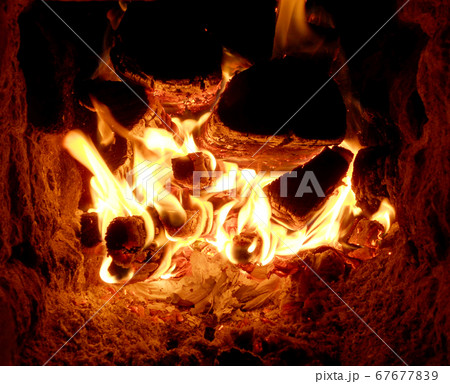 Beautiful red fire from slice wood, dark grey Beautiful red fire from slice wood, dark grey 67677839