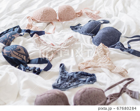 Deep blue and beige laced bras and thongs. - Stock Photo
