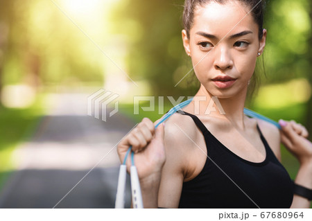 Motivated Asian Girl In Sportswear Posing With Jump Skipping Rope Outdoors 67680964