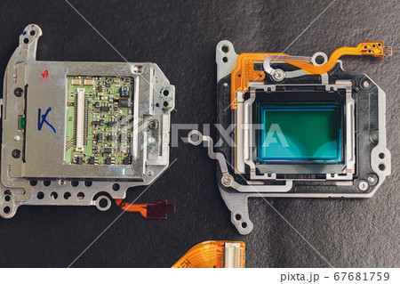 Engineer and technician Minitures are fixing camera mirror box assembly , Miniture workers are checking optics and carry out maintenance and cleaning of the broken camera at the service center. 67681759