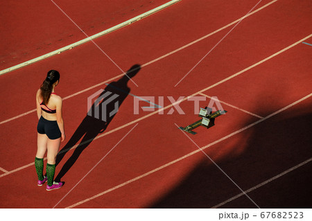 girl runner stand on starting line 67682523