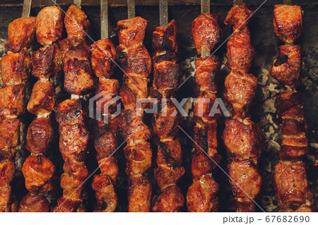 Shish kebab. Pork or lamb meat pieces being fried on a charcoal grill. Shish kebab. Pork or lamb meat pieces being fried on a charcoal grill. 67682690