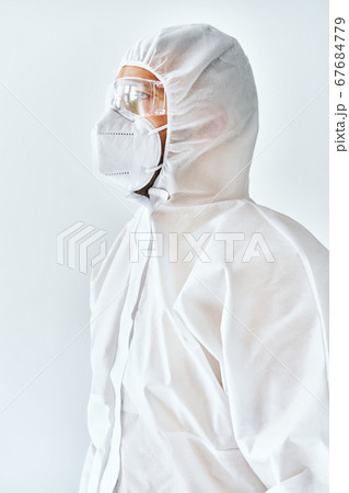 Profile view of doctor in protective medical suit, face mask and glasses 67684779