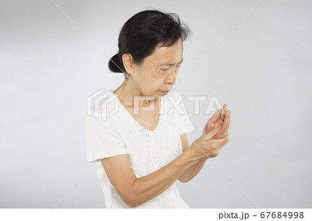 old asian woman feel hand muscle injury old asian woman feel hand muscle injury 67684998