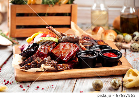 Big hot barbecue meat and vegetables plateau 67687965