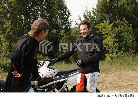 Young bikers chatting after race Young bikers chatting after race 67688898