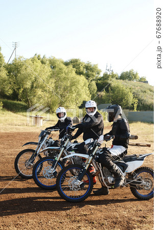 Motorcyclists talking before competition Motorcyclists talking before competition 67688920