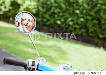 Young woman ride on retro motorbike around Young woman ride on retro motorbike around 67689513