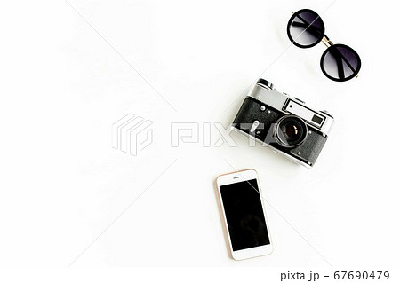 Traveler accessories concept on white background. Retro camera, telephone, sunglasses. Summer background. Flat lay 67690479