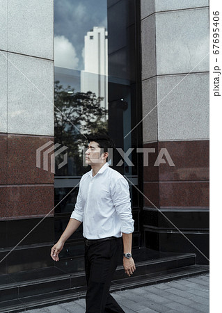Asian businessman walking on the street. Asian businessman walking on the street. 67695406
