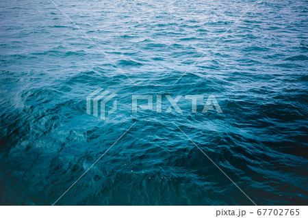 Blue sea surface, top view. Dark mood tone. 67702765