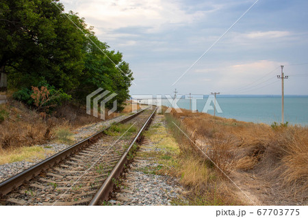 The old railway runs along the coast along the sea.Space for text The old railway runs along the coast along the sea.Space for text 67703775