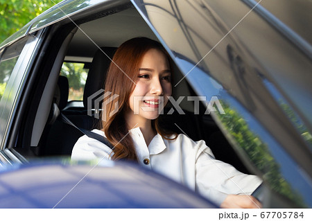 Young asian woman driving a car Young asian woman driving a car 67705784