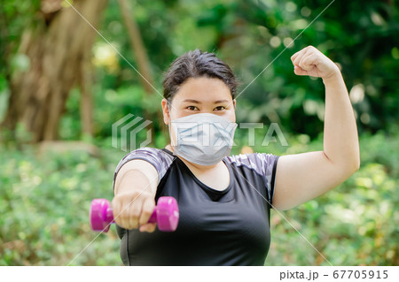 Healthy strong women exercise workout wear protective face mask for virus protection 67705915
