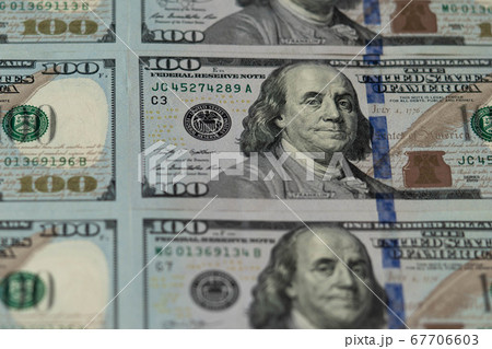 One hundred dollars. Benjamin Franklin. US dollars background. Closeup of a lot of banknotes hundred dollar bills. American currency. One hundred dollars. Benjamin Franklin. US dollars background. Closeup of a lot of banknotes hundred dollar bills. American currency. 67706603