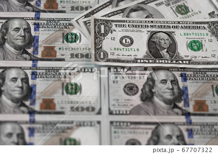 One hundred dollars and one dollar bills. Benjamin Franklin. US dollars background. Closeup of a lot of banknotes hundred dollar bills. American currency. 67707322