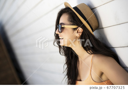 Pretty brunette girl in jeans shorts looking cheerful Pretty brunette girl in jeans shorts looking cheerful 67707325