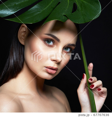 beautiful girl under palm umbrella. Beautiful 67707636