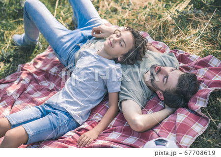 Dad and son resting ang looking relaxed Dad and son resting ang looking relaxed 67708619