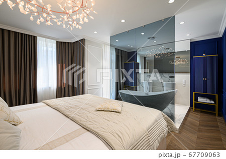 Big comfortable double bed in elegant classic bedroom 67709063