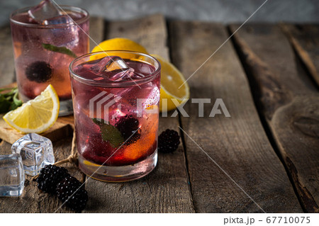 Blackberry lemonade on rustic wood background Blackberry lemonade on rustic wood background 67710075