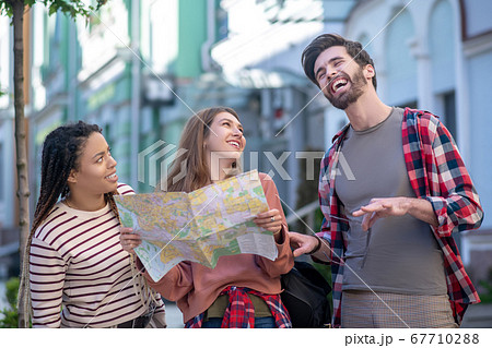 Bearded guy and two girls laughing fun outdoors Bearded guy and two girls laughing fun outdoors 67710288