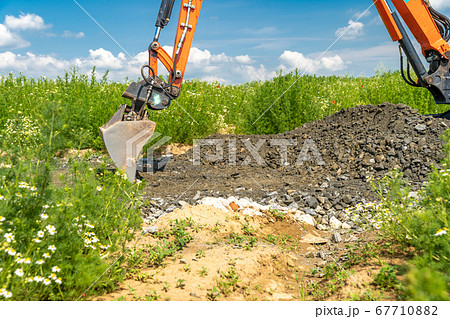 the excavator digs gravel for road construction 67710882
