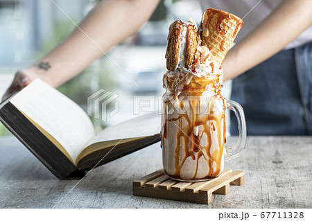 Milky summer cocktail with waffle and mapple syrup  67711328