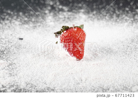 A single stawberry on the flour 67711423