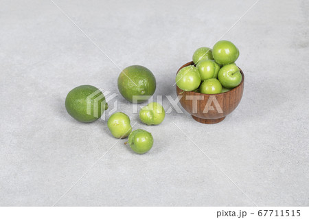Cherry plums and lime fruits on the kitchen table 67711515