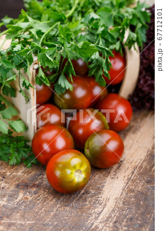 Fresh homemade tomatoes with parsley leaves on Fresh homemade tomatoes with parsley leaves on 67712101